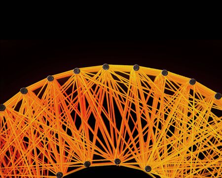 abstract plastic lin yellow rope with iron knot line on black backgroundの写真素材