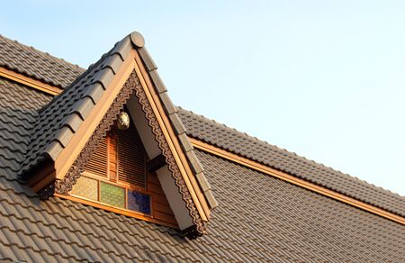 Thai exterior roof top of wood huse in vintage style on clear skyの写真素材