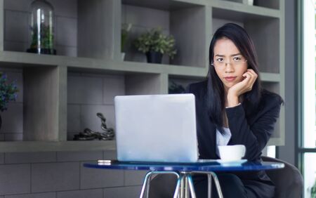 smart asian woman working with laptop on living room in work at home conceptの写真素材