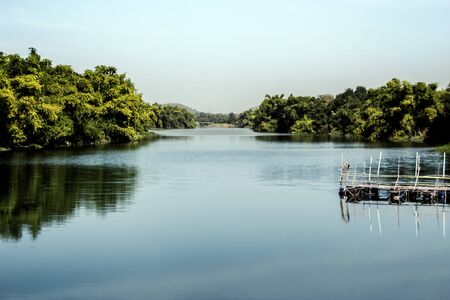 landscape riverside at asian Thailand with home and bridgeの写真素材