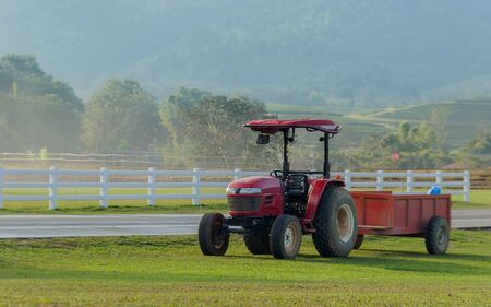 red tractor car on farm in agriculture in peaceful