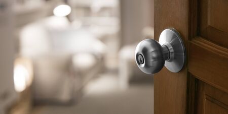 open door to blur living room in banner size, Focus on wood door with lockの写真素材