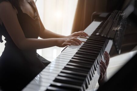 Hand kids practice playing pianoの写真素材