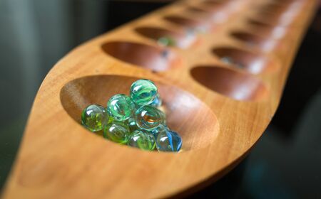 close up glass ball in kalaha game for practice math and strategic thinkingの写真素材