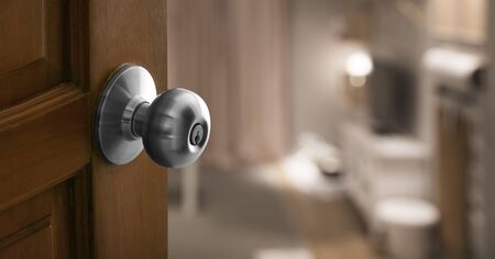 open door to blur living room in banner size, Focus on wood door with lockの写真素材