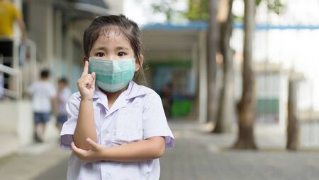 Asian kids student command action with face mask to protect coronavirus pandemic for back to schoolの写真素材
