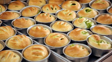 Fresh buns with crust on hot baker plate homemade bakery shop