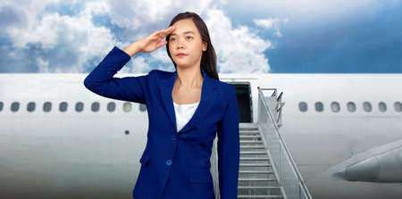 Asian woman air hostage uniform with smile welcome at airplane doorの写真素材