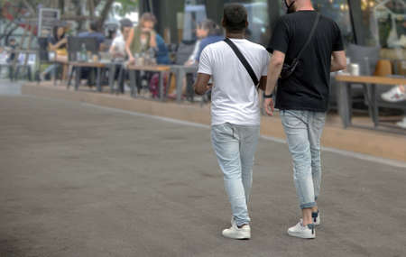 friendship of LGBT mix race walking together on the city streetの写真素材