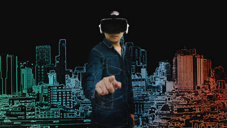 abstract asian man pointing on graphic digital city with virtual glasses in technology conceptの写真素材