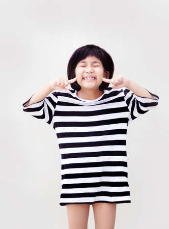 happy asian kid model with short hair on white isolated backgroundの写真素材