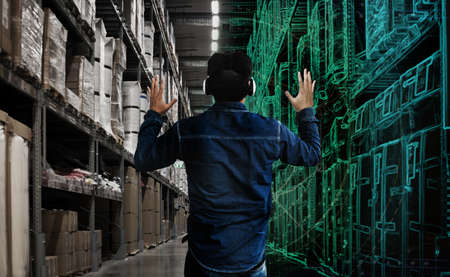 backyard asian man controld digital graphic logistic and real store with virtual glasses on screenの写真素材