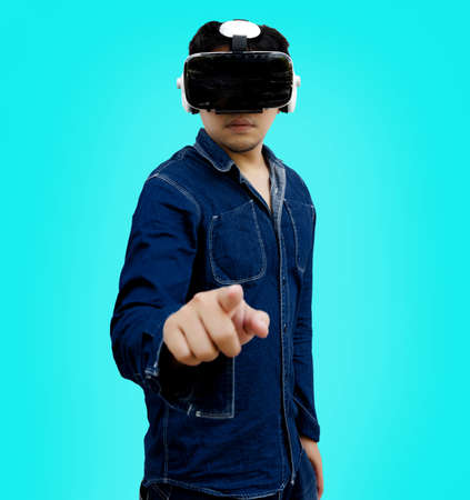 abstract asian man pointing on screen with virtual glasses in VR technology on isolated background  concept (include clipping path)の写真素材