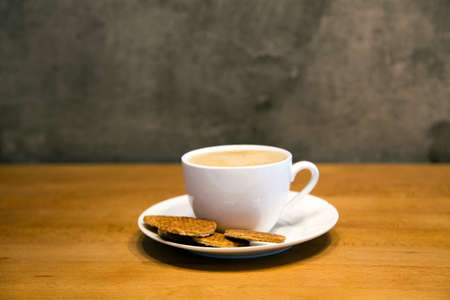 reserve break time with  homemade stroopwafel snack and hot coffee cup on wood table made from daugh and syrup in original tast from dutchの写真素材