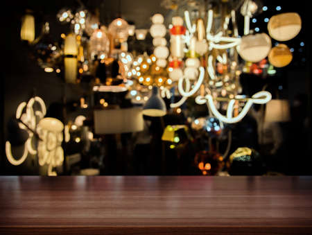 wood table top counter for display product with light in creative pattern at night clubの写真素材