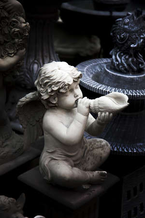 cement figure of baby cupid angle in Roman style from bake cray factory for decorate gardenの写真素材