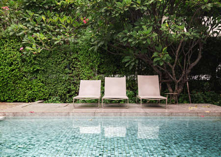 relax outdoor seat next to decking around outdoor swimming pool on resortの写真素材