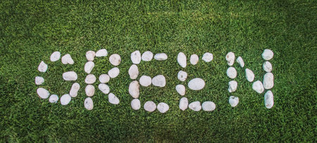 go green concept with arranging white stones in green to send the massage with long banner sizeの写真素材