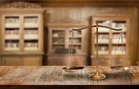copper scales of balancing in the truth of legal concept with classic library on backgroundの写真素材