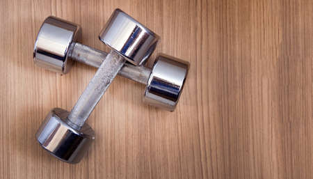 Two dumbbells on wooden floorの写真素材