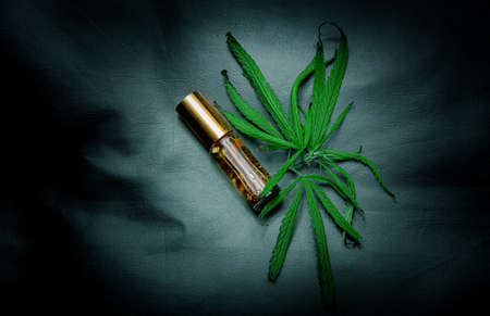 canabis oil in tube for healthy herb product on black leatherの写真素材