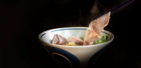 close up hot pork boild with chopstick on noodle soup for asian food