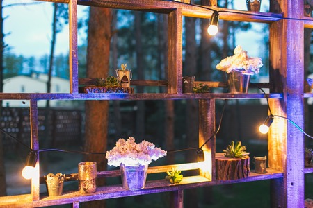 Rustic wedding decor, shelf stand with lilac arrangements and succulents.の写真素材