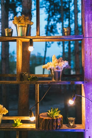 Rustic wedding decor, shelf stand with lilac arrangements and succulents.の写真素材