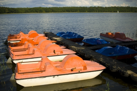 Pedal boats moored at a marina on the lake .の写真素材