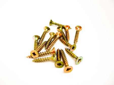 Pile of wood screws on a white background.の写真素材