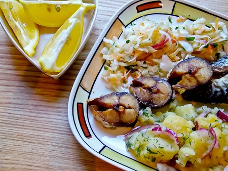 Roasted mackerel garnish with boiled potatoes and cabbageの写真素材