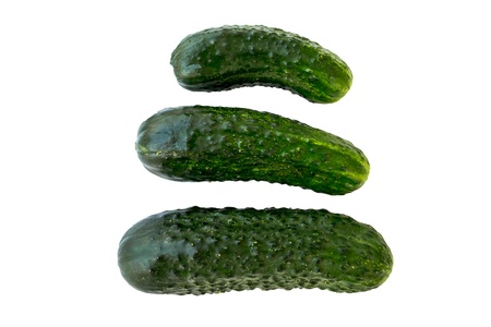 Three fresh cucumbers isolated on whiteの写真素材