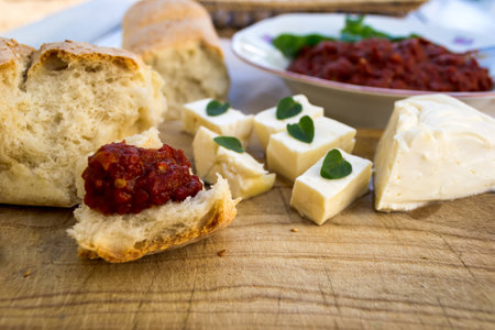 Homemade chutney, freshly baked bread and fresh white cheeseの写真素材