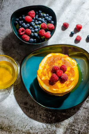 Delicious pancakes close up with fresh berries and honeyの写真素材