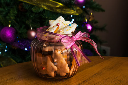 Close up view of plate with tasty Christmas cookies on wooden table
