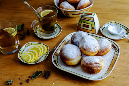 Doughnut dusted with powdered sugar for breakfast with herbal teaの写真素材