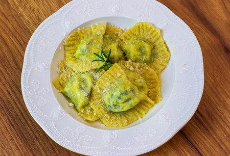 Serving Homemade Pasta Ravioli with Cow Butter Sauce in a white plate on the tableの写真素材