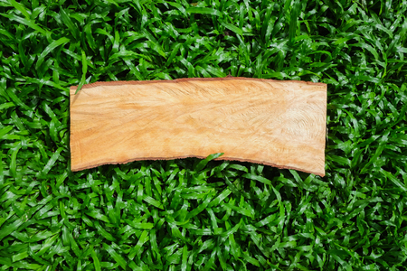 Empty Wooden signboard against grass abstract backgroundの写真素材