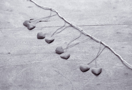 Small red hearts on the wooden tableの写真素材