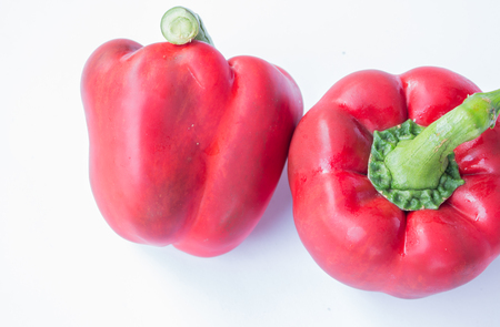 Red sweet peppers on white backgroundの写真素材