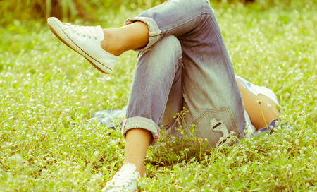 Lazy women lie down on grass in the gardenの写真素材