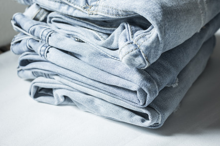 Stack of denim jeansの写真素材