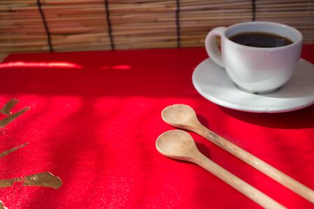 Cup of coffee on red with space use for backgroundの写真素材