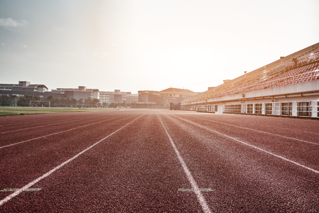 A football field,   runway  and grandstand in a stadiumのeditorial素材