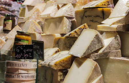 PARIS, FRANCE-DECEMBER 7, 2013: Different types of mature yellow cheese on the stand on Christmas marketのeditorial素材