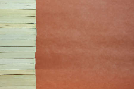 A smooth stack of vintage books on a brown background. High quality photo.