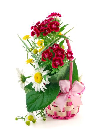 the wattled basket from a rod with natural flowers is isolated on a white backgroundの写真素材