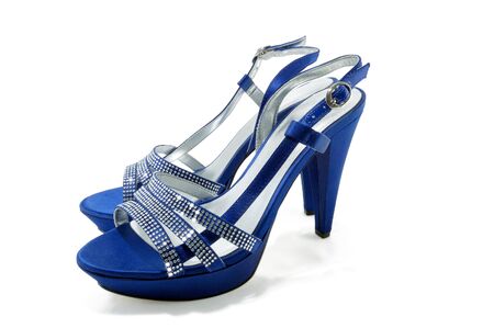 elegant female sandals on a high heel are isolated on a white backgroundの写真素材
