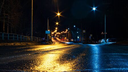Wet asphalt in a night city. Bright reflections from multi-colored lanterns.の写真素材
