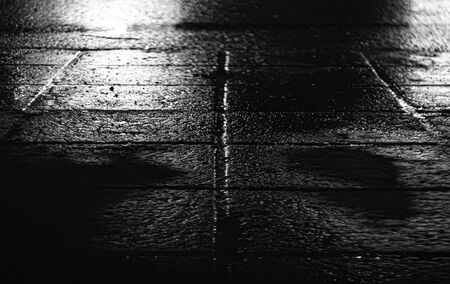 night photography concrete tile high definition. wet asphalt after rain. black and white background.の写真素材